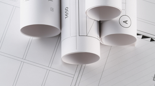 Building Information Modeling (BIM) 3D architectural model on computer screen with blueprints